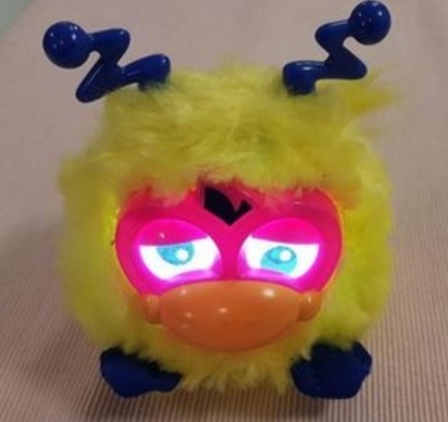 Silly little yellow furby that looks kind of sad